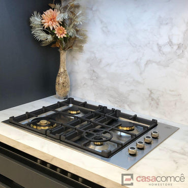 Cooktop Bertazzoni a gás 4 bocas inox 75cm sobre bancada de mármore com decoração.