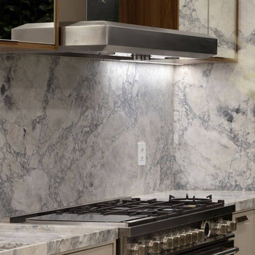 Coifa Bertazzoni Vavano de Parede Inox 122cm: coifa de parede em inox escovado, formato retangular, iluminação e duto visível sobre fogão