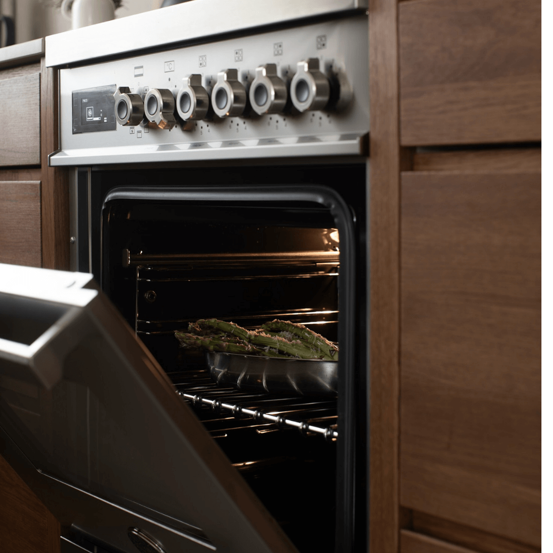 Forno elétrico Bertazzoni com pratos assando, 6 queimadores, design inox e painel moderno na cozinha.