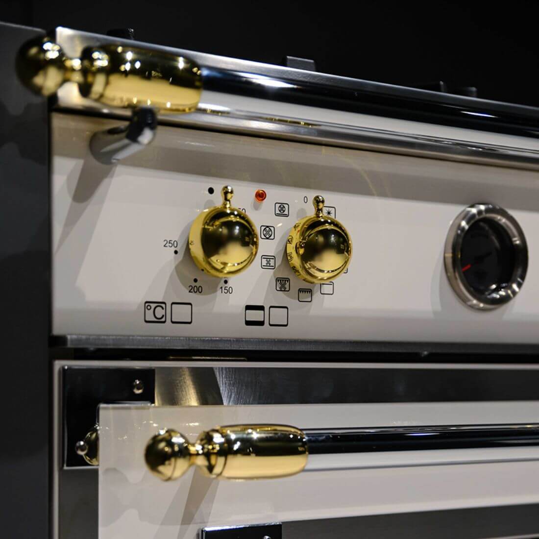 Fogão Bertazzoni Heritage Marfim 120cm 6 Bocas Forno Elétrico 138L - detalhe de painel e puxadores dourados em fogão de piso creme estilo italiano