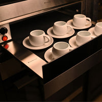 Gaveta Aquecida Debacco Montreal Inox e Vidro 60cm em inox com frente de vidro, puxador discreto e bandeja interna com xícaras